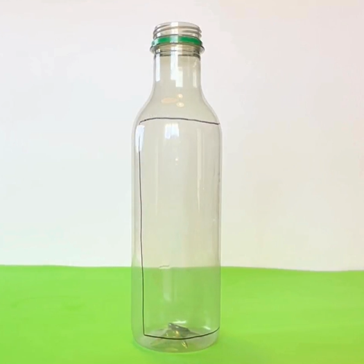 an empty plastic bottle with a line drawn on it