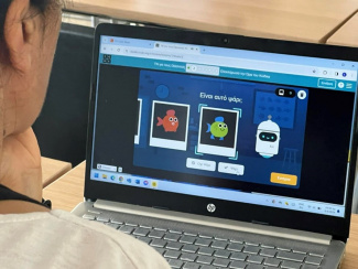 Teacher looking at a laptop screen with machine learning app