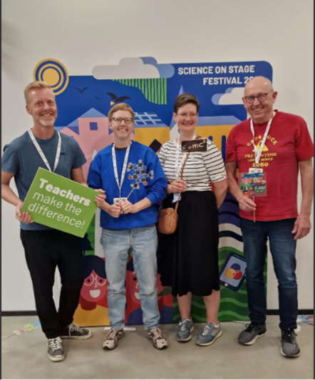 Group photo with four smiling teachers, one holds a sign "Teachers make the difference"