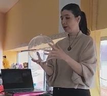 A workshop presenter with a transparent globe in her hands