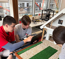 A group of student with the model of a smart house