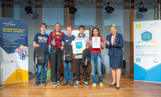 A group of people standing on stage