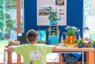 A boy is sitting in front of a screen