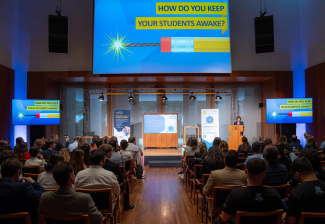 Audience sitting in front of a screen