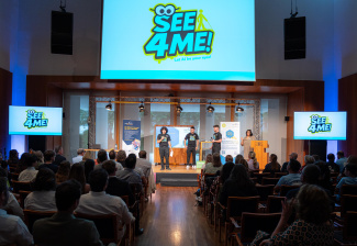 People standing on stage in front of an audience