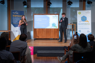 Two people are giving a presentation on stage