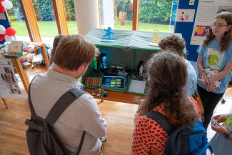 People are standing around a screen
