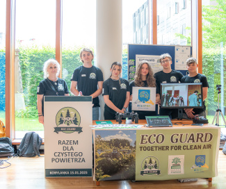 A group of people standing behind a table