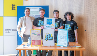 Four people standing behind a table