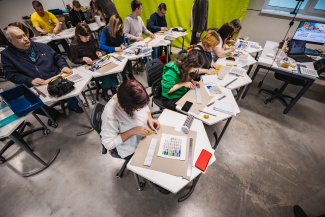 A group of teachers working individually during a workshop