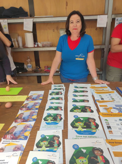 A teacher at a stand with colourful brochures