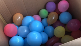 Coloured ballons in a cardbord box