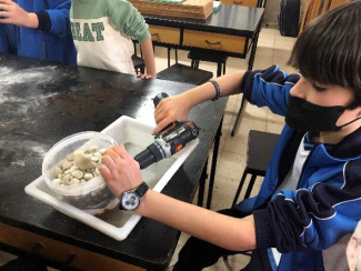 Student experimenting with beach sand