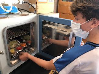 Student in front of a lab oven