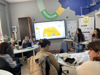 Workshop presenter and participants in a seminar room