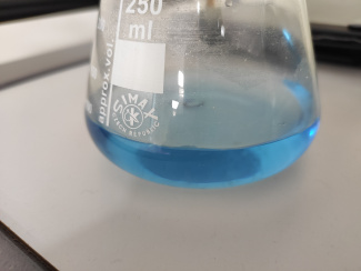 Water with indicator before the experiment (blue)