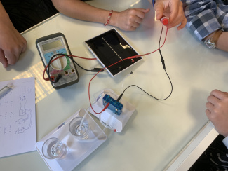 A hydrogen fuel cell electrolyser with a solar cell being built by students in class