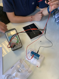 A hydrogen fuel cell electrolyser with a solar cell being built by students in class