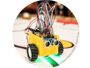 a robot with a yellow case, two wheels, and colourful wires sticking out