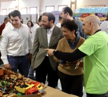 A group of four people at a stand with science exhibits