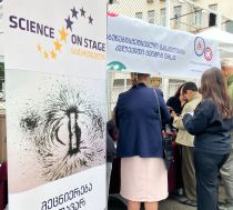 A banner with the Science on Stage Georgia logo and participants of a science fair
