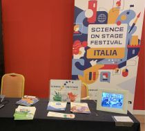 A display of leaflets, tablet and banner at a conference stand