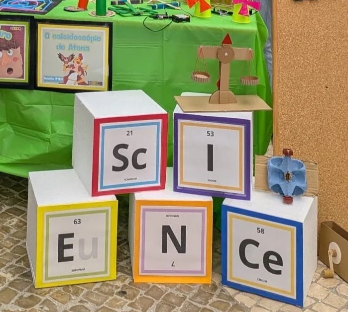 Five coloured boxes with letters assembling the word "Science"