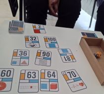 View of playing cards with numbers as part of a science board game