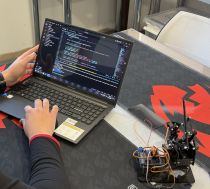 A laptop and a robotics model