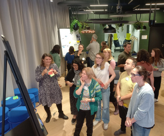 a group of people looking at a whiteboard
