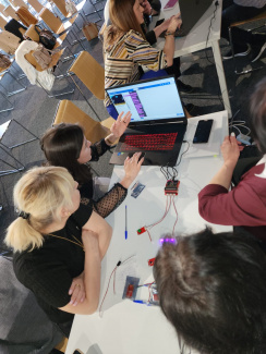Teachers working with laptop and controllers during a workshop