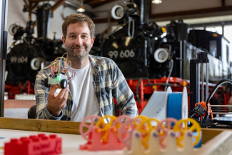 Marco Düvelmeyer holding a small robot
