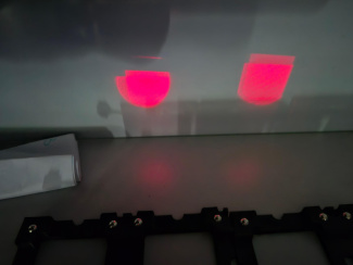 two red light patterns on a white wall