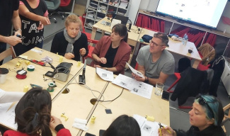 Teachers are sitting around a table