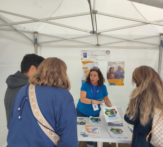 Four people in conversation at a science fair