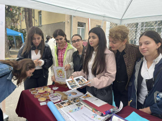 A group of young women at a stand during a science fair