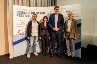 Four people in front of a sponsor wall at the Science on Stage Festival