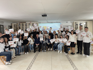 A group photo of festival participants with certificates