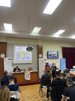 Two presenters on a podium during a science conference