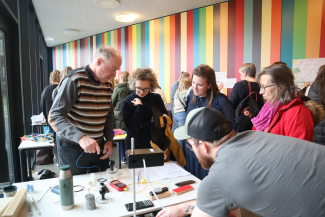 Visitors at a stand with science exhibits