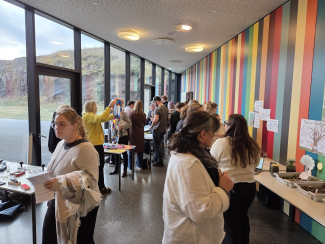 Visitors of a science exhibition in a bright glass-walled conference venue