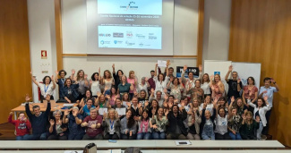 A cheering group of conference participants seen from above