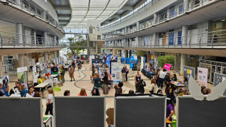Wide-angle view of a science exhibition with visitors