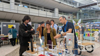 Visitors at a stand with science exhibits