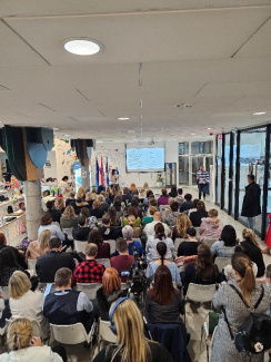 View from the back of the audience in a full lecture hall