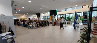 A wide-angle view of the audience in a plenary room