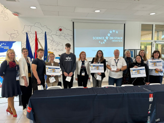 A group of conference participants with award certificates