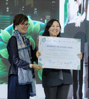 Two people holding an award certificate