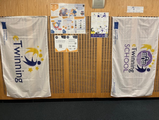 Two banners, posters and flyers on a wall during a science conference