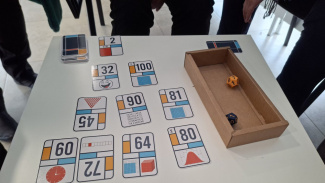 Cards of a science board game on a table